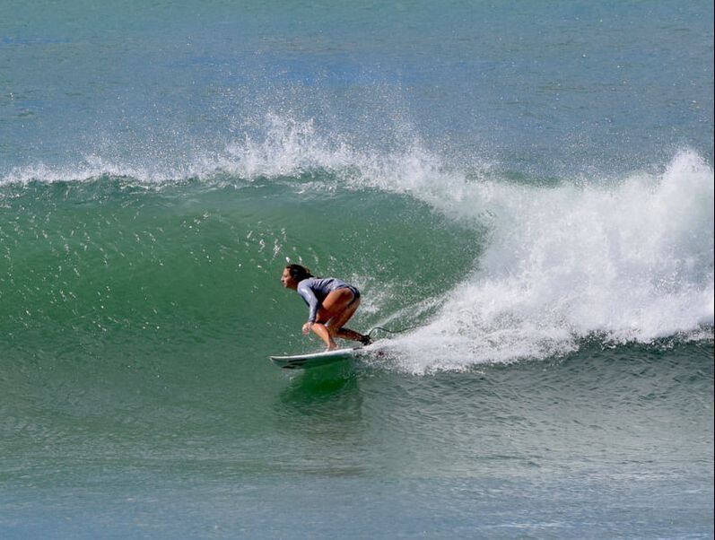 teen girl surfs alone